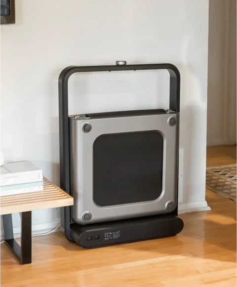 Movaped X21 foldable treadmill stored upright to save space at home
