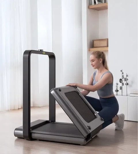 Woman folding the Movaped X21 treadmill for compact storage at home
