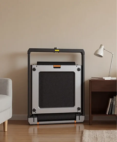 Movaped X25 foldable treadmill stored upright to save space at home
